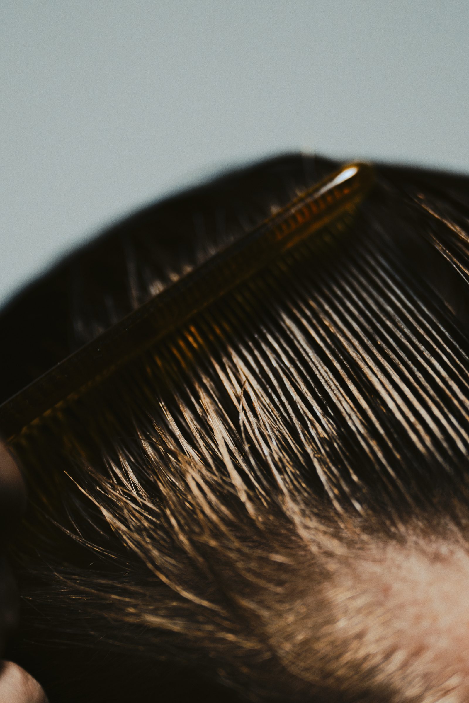 Comb pulling through hair